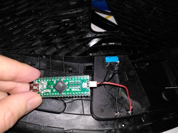 Wiring the Teensy reset pin to the battery pins. So you can enter the bootloader without opening the keyboard